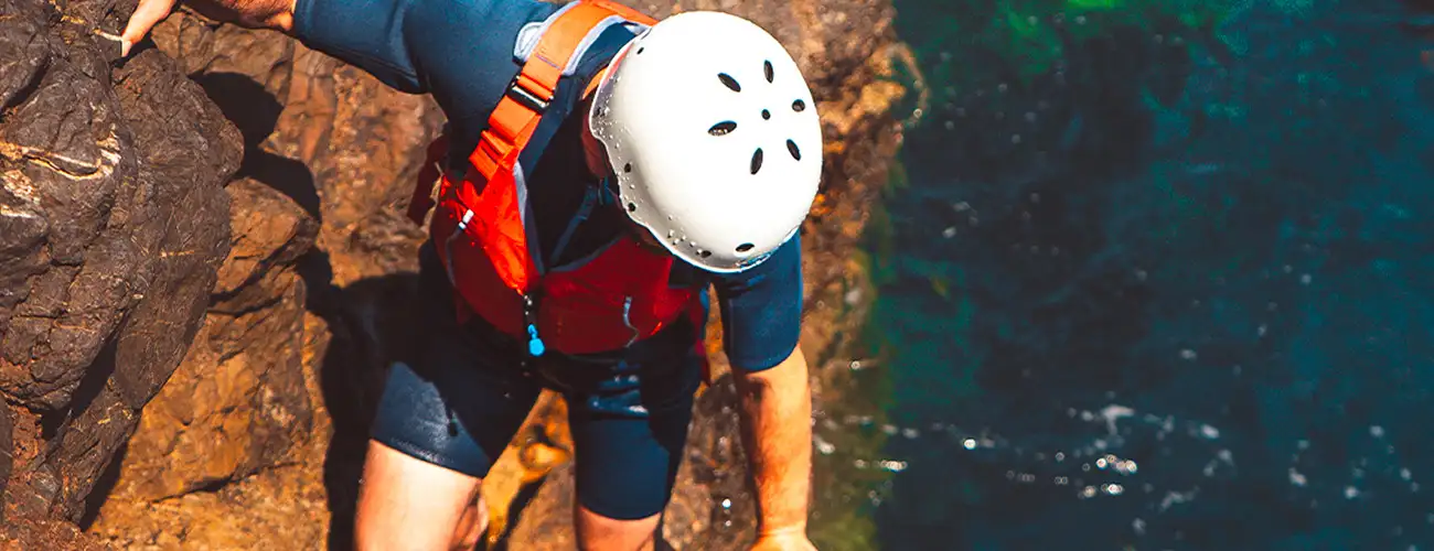 Participant exploring Ibiza’s coastline during a guided coasteering activity