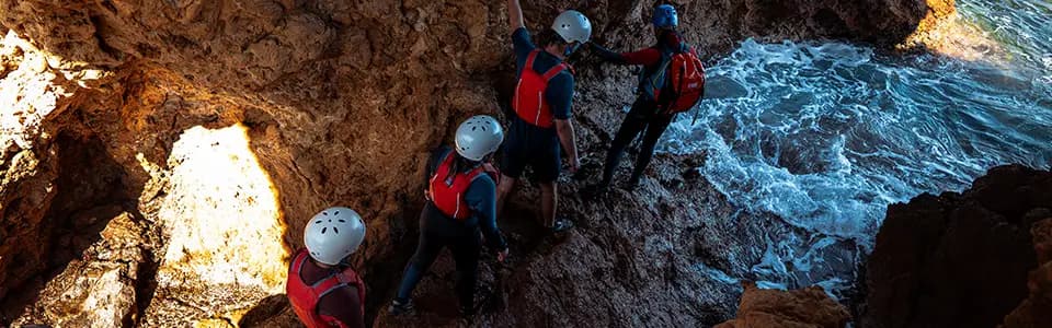 Discover hidden rocky channels and coastal formations during your coasteering adventure in Ibiza. Navigate through stunning turquoise waters and explore the island's wild coastline with expert guides.